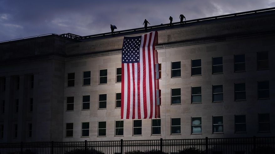 A large American flag is unfurled at the Pentagon ahead of ceremonies at the National 9/11 Pentagon Memorial to honor the 184 people killed in the 2001 terrorist attack on the Pentagon, in Washington, Friday Sept. 11, 2020. (AP Photo/J. Scott Applewhite) ** FILE **