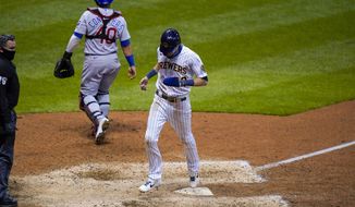 Milwaukee Brewers&#39; Christian Yelich scores the game-winning run from third on a sacrifice fly by Ryan Braun during the ninth inning of a baseball game against the Chicago Cubs Friday, Sept. 11, 2020, in Milwaukee. The Brewers won 1-0. (AP Photo/Morry Gash)