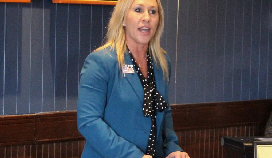 FILE - In this March 3, 2020, file photo, Republican Marjorie Taylor Greene speaks to a GOP women&#x27;s group in Rome, Ga. The Democratic candidate running against Republican Marjorie Taylor Greene, who has expressed support for the QAnon conspiracy theory and been criticized for other incendiary comments, is dropping out of their race for a U.S. House seat representing northwest Georgia. Democrat Kevin Van Ausdal bowed out of the race on Friday, Sept. 11, 2020.  (John Bailey/The Rome News-Tribune via AP, File)