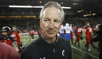 FILE - In this Nov. 18, 2016 file photo, Cincinnati coach Tommy Tuberville walks off the field after the team&#x27;s NCAA college football game against Memphis in Cincinnati. Democratic Sen. Doug Jones of Alabama has called Republican challenger Tommy Tuberville “Coach Clueless” for the former football coach&#x27;s recent comments about the coronavirus. Jones attacked Tuberville in a campaign appearance Friday, Sept. 11, 2020. (AP Photo/John Minchillo, File)