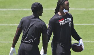 FILE - In this Aug. 4, 2020, file photo, Atlanta Falcons running back Todd Gurley, right, gets five from wide receiver Calvin Ridley after making a reception during NFL football practice in Flowery Branch, Ga. Gurley believes he and his new team are a perfect match as he seeks to rejuvenate a career affected by knee injuries. (Curtis Compton/Atlanta Journal-Constitution via AP)