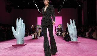 FILE - The Christian Siriano collection is modeled during Fashion Week in New York on Feb. 6, 2020. With no celebs in the front row, no paparazzi chasing models down the streets, no stiletto-heeled crowds and no live shows at all, is there even a point to doing Fashion Week in 2020? Well, yes, say organizers: It’s about business. And jobs. And survival. (AP Photo/John Minchillo, File)