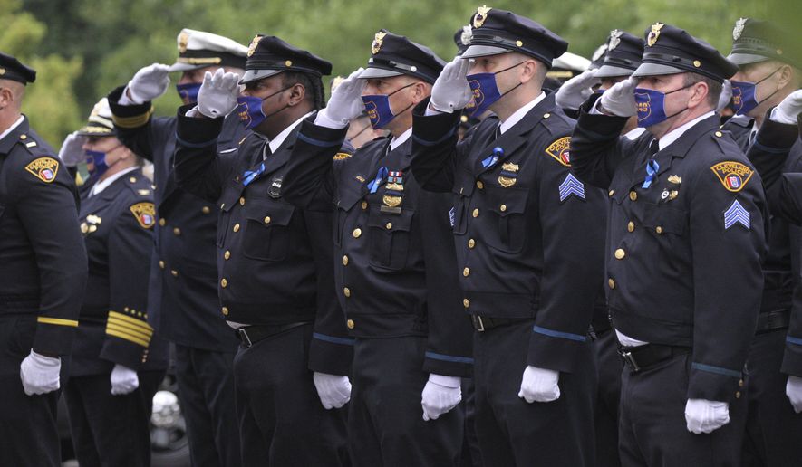Officers salute as family members of slain Cleveland Detective James Skernivitz leave the A. Ripepi &amp;amp; Sons Funeral Home in Middleburg Heights, Ohio on Friday morning, Sept. 11, 2020. Skernivitz was killed on Sept. 3 while working undercover in Cleveland. (David Petkiewicz/Cleveland.com via AP)