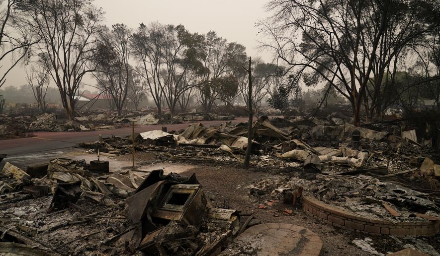 Rubble remains from an area destroyed by the Almeda Fire, Friday, Sept. 11, 2020, in Talent, Ore. (AP Photo/John Locher)