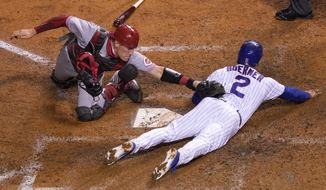 Chicago Cubs&#39; Nico Hoerner (2) is safe at home past the tag of Cincinnati Reds catcher Tyler Stephenson during the fourth inning of a baseball game Thursday, Sept. 10, 2020, in Chicago. (AP Photo/Charles Rex Arbogast)