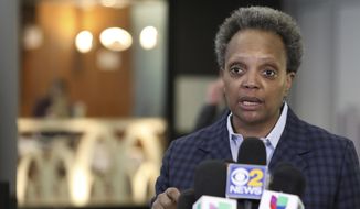 In this  Sunday, March 15, 2020 file photo, Chicago Mayor Lori Lightfoot speaks to reporters at O&#39;Hare International Airport in Chicago. The barbs that have flown between President Donald Trump and his family and Chicago Mayor Lori Lightfoot haven’t prevented either side from engaging occasionally in niceties.  (AP Photo/Teresa Crawford, File)