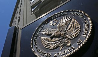 This June 21, 2013, file photo, shows the seal affixed to the front of the Department of Veterans Affairs building in Washington. (AP Photo/Charles Dharapak, File)  ** FILE **