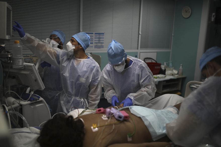 A medical crew works at a patient affected with COVID-19 in a Marseille hospital, southern France, Thursday, Sept.10, 2020. As the Marseille region has become France&#x27;s latest virus hotspot, hospitals are re-activating emergency measures in place when the pandemic first hit to ensure they&#x27;re able to handle growing new cases. (AP Photo/Daniel Cole)