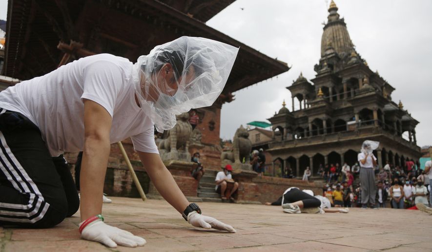 FILE - In this June 30, 2020, file photo, Nepalese youth perform a play as part of a protest demanding better COVID-19 management at Patan Durbar Square near Kathmandu, Nepal. (AP Photo/Niranjan Shrestha, File)