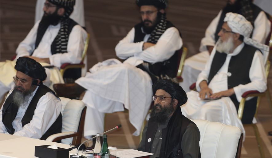 Taliban co-founder Mullah Abdul Ghani Baradar speaks, bottom right, talks at the opening session of the peace talks between the Afghan government and the Taliban in Doha, Qatar, Saturday, Sept. 12, 2020. (AP Photo/Hussein Sayed)