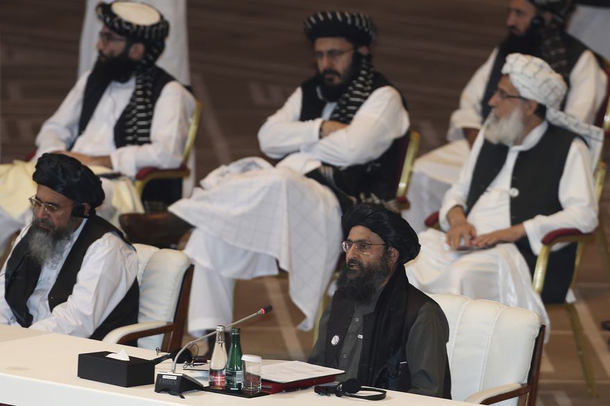 Taliban co-founder Mullah Abdul Ghani Baradar speaks, bottom right, talks at the opening session of the peace talks between the Afghan government and the Taliban in Doha, Qatar, Saturday, Sept. 12, 2020. (AP Photo/Hussein Sayed)