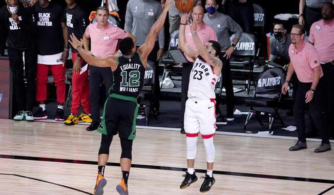 Toronto Raptors&#x27; Fred VanVleet (23) attempts a three-pointer against Boston Celtics&#x27; Grant Williams (12) during the second half of an NBA conference semifinal playoff basketball game Friday, Sept. 11, 2020, in Lake Buena Vista, Fla. The Celtics won 92-87. (AP Photo/Mark J. Terrill)