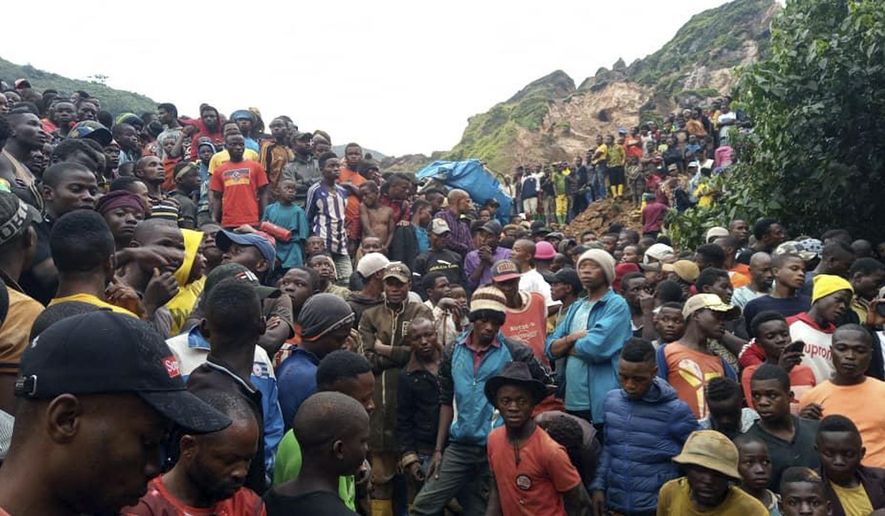 People gather at the scene of a gold mine collapse near the town of Kamituga, South Kivu province, in eastern Congo Friday, Sept. 11, 2020. More than 50 people are dead after landslides collapsed three artisanal gold mines near the town of Kamituga in eastern Congo&#39;s South Kivu province on Friday, officials said. (Jeff Mwenyemali/Maisha RDC via AP)