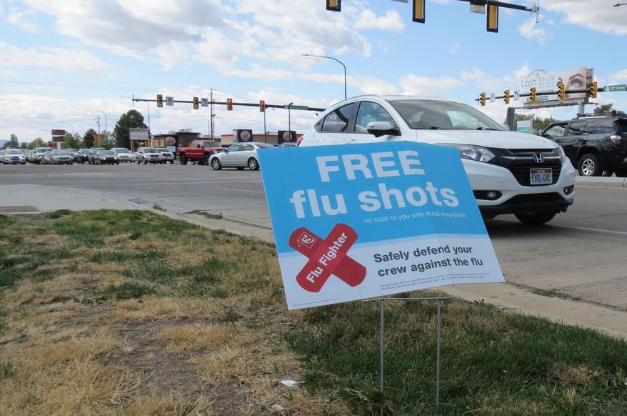 A sign advertising flu shots is displayed on Tuesday, Sept. 8, 2020, in in Ogden, Utah. The annual flu season is gearing up alongside the coronavirus pandemic, and Utah health officials are encouraging people to get their flu shots. (Tim Vandenack/Standard-Examiner via AP)