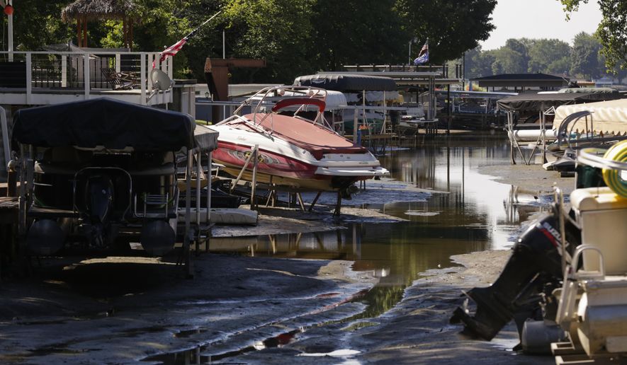 Boats sit well above the water level of the Tippecanoe River on a man-made canal, Friday, Sept. 4, 2020 in Monticello, Ind. (Nikos Frazier/Journal &amp;amp; Courier via AP)