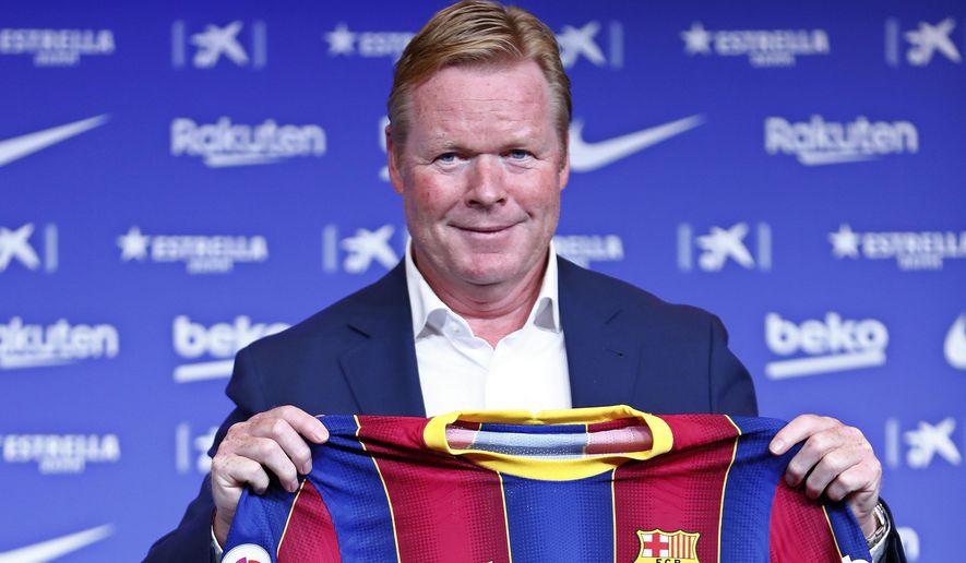 Ronald Koeman holds up a Barcelona soccer shirt during his official presentation as coach for FC Barcelona in Barcelona, Spain, Wednesday, Aug. 19, 2020. Barcelona officially announced earlier on Wednesday a deal with Koeman to become their coach five days after the team&#39;s humiliating 8-2 loss to Bayern Munich in the Champions League quarterfinals. Barcelona says the former defender&#39;s deal runs through June 2022. Koeman replaces the fired Quique Setien. (AP Photo/Joan Monfort)
