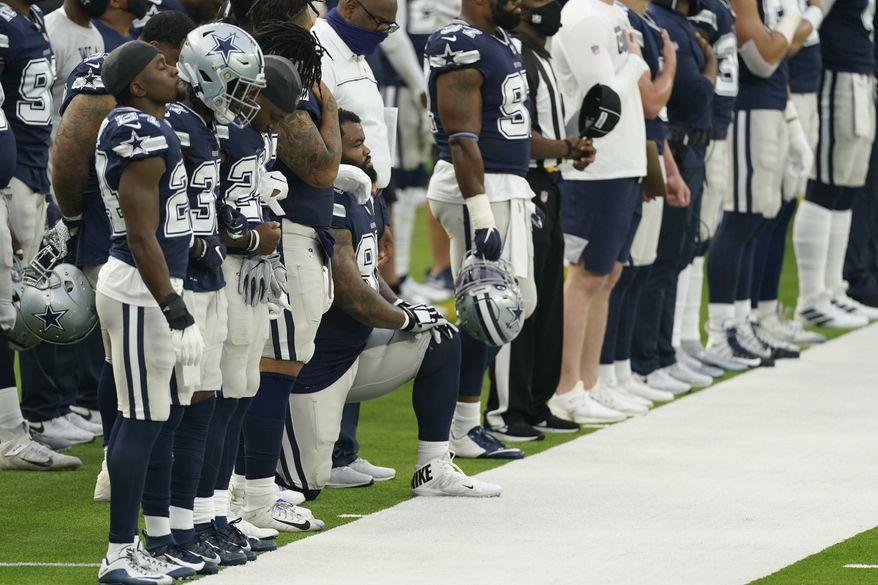 A member of the Dallas Cowboys kneels during the national anthem before an NFL football game against the Los Angeles Rams Sunday, Sept. 13, 2020, in Inglewood, Calif. (AP Photo/Ashley Landis)