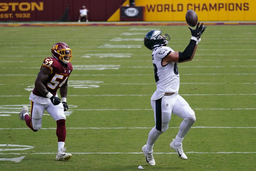 Philadelphia Eagles tight end Dallas Goedert (88) catches a pass on his way to scoring a touchdown against Washington Football Team Kevin Pierre-Louis (54) during the first half of an NFL football game, Sunday, Sept. 13, 2020, in Landover, Md. (AP Photo/Alex Brandon)