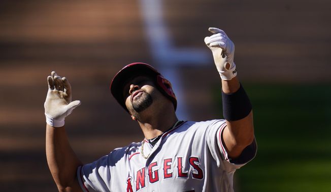Los Angeles Angels&#x27; Albert Pujols gestures as he crosses home plate after hitting a two-run home run in the eighth inning of a baseball game Sunday, Sept. 13, 2020, in Denver. (AP Photo/David Zalubowski)