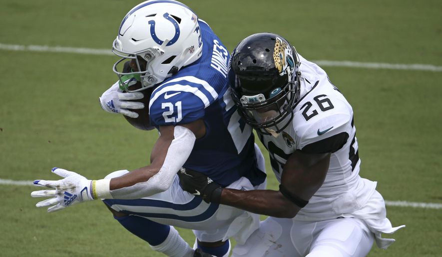 Indianapolis Colts running back Nyheim Hines (21) scores a touchdown on a 12-yard run as he is brought down by Jacksonville Jaguars safety Jarrod Wilson (26) during the first half of an NFL football game, Sunday, Sept. 13, 2020, in Jacksonville, Fla. (AP Photo/Stephen B. Morton)