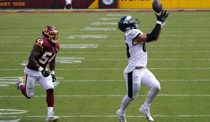 Philadelphia Eagles tight end Dallas Goedert (88) catches a pass on his way to scoring a touchdown against Washington Football Team Kevin Pierre-Louis (54) during the first half of an NFL football game, Sunday, Sept. 13, 2020, in Landover, Md. (AP Photo/Alex Brandon)
