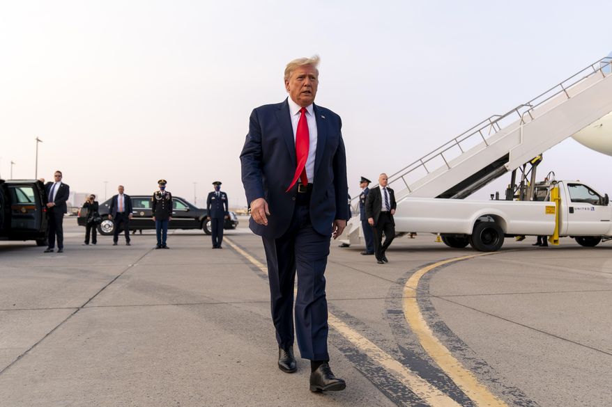 President Donald Trump walks towards member of the media as he arrives at Reno-Tahoe International Airport in Reno, Nev., Saturday, Sept. 12, 2020, to travel to a rally in Minden, Nev. (AP Photo/Andrew Harnik)