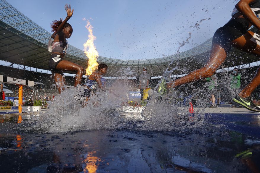 Kenya's Hyvin Kiyeng, left, competes during the women's 3,000 meters steeplechase at the ISTAF Athletics Meeting in Berlin, Germany, Sunday, Sept. 13, 2020. (AP Photo/Markus Schreiber)