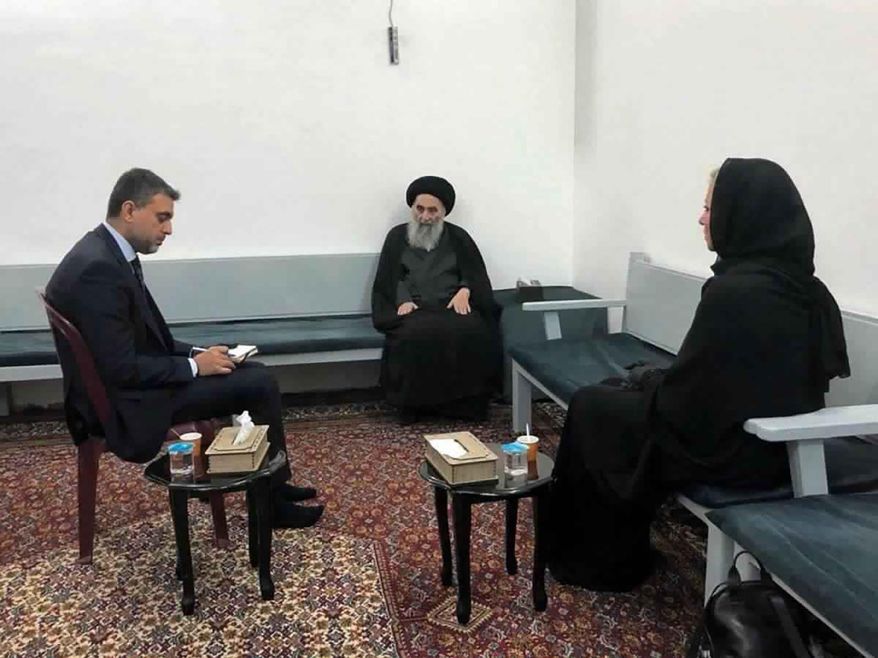 This handout photo from the office of Grand Ayatollah Ali al-Sistani shows Iraq&#39;s top Shiite cleric Grand Ayatollah Ali al-Sistani, center, meeting with U.N. envoy to Iraq Jeanine Hennis-Plasschaert, right, in Najaf, Iraq, Sunday, Sept. 13, 2020. In a statement released by his office after meeting the U.N. envoy Al-Sistani threw his support behind the prime minister’s announcement to hold parliamentary elections ahead of schedule next year, a key demand of protesters. (Office of Grand Ayatollah Ali al-Sistani, via AP)