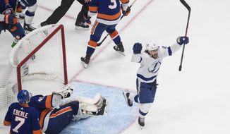Tampa Bay Lightning&#39;s Brayden Point (21) celebrates his goal against New York Islanders goalie Semyon Varlamov (40) during the third period of an NHL Eastern Conference final playoff game in Edmonton, Alberta, on Sunday, Sept. 13, 2020. (Jason Franson/The Canadian Press via AP)