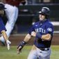 Seattle Mariners&#39; Dylan Moore, right, celebrates his run scored against the Arizona Diamondbacks with teammate Evan White, left, during the ninth inning of a baseball game Sunday, Sept. 13, 2020, in Phoenix. (AP Photo/Ross D. Franklin)