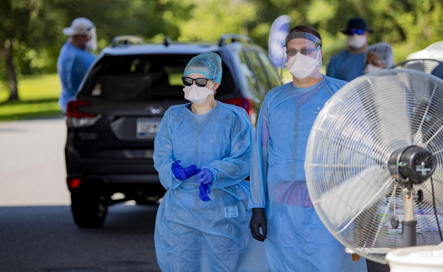 Tidelands Health medical professionals conduct a drive-through COVID-19 testing site Friday July 17, 2020 at Myrtle Beach Pelicans Ballpark in Myrtle Beach, S.C. (Josh Bell/The Sun News via AP)