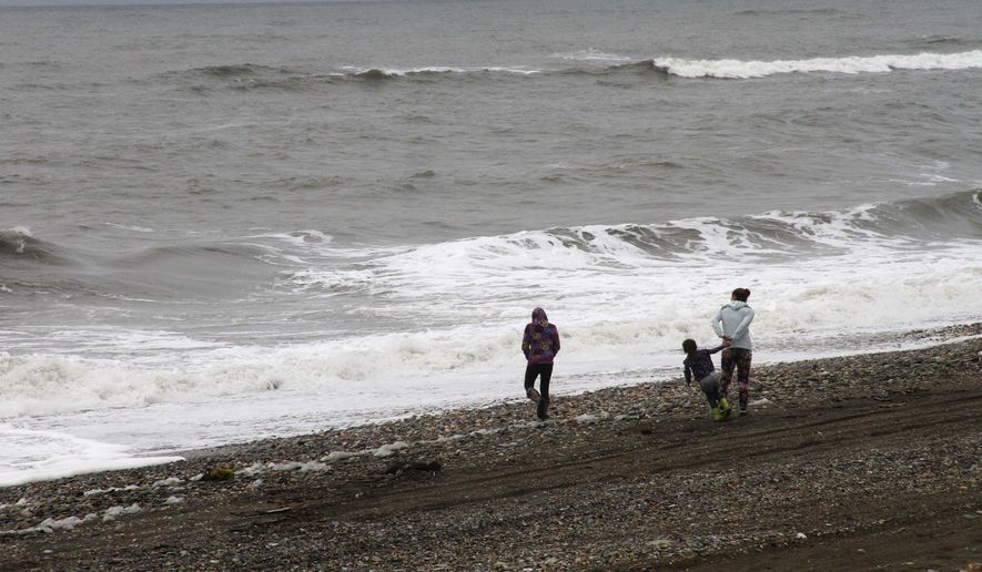 Alaskans comb the beach along the Bering Sea to clean up debris. The exact origin of the garbage that washed up this summer is unclear, but local leaders said it was unlike anything they had seen before. (Associated Press)