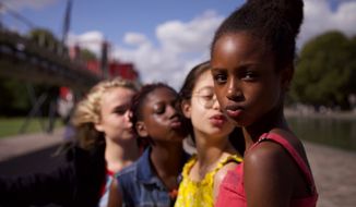 This image released by Netflix shows the cast of the coming-of-age film &quot;Cuties.&quot; The backlash to the French independent film Mignonnes, or Cuties, started before it had even been released because of a poster that went viral for its provocative depiction of its young female actors. (Netflix via AP, File)