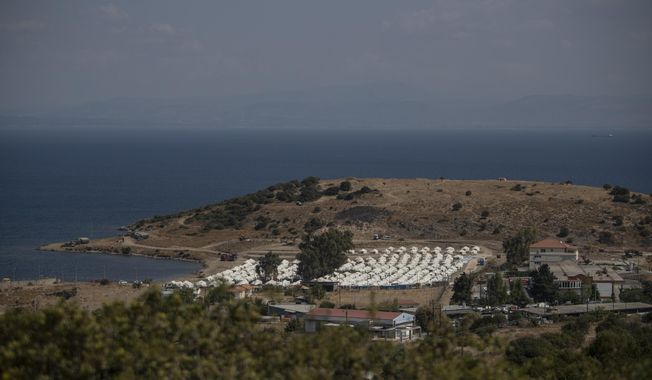 A general view of the temporary camp for refugees and migrants near Mytilene town, on the northeastern island of Lesbos, Greece, Sunday Sept. 13, 2020. Greek authorities have been scrambling to find a way to house more than 12,000 people left in need of emergency shelter on the island after the fires deliberately set on Tuesday and Wednesday night gutted the Moria refugee camp. (AP Photo/Petros Giannakouris)