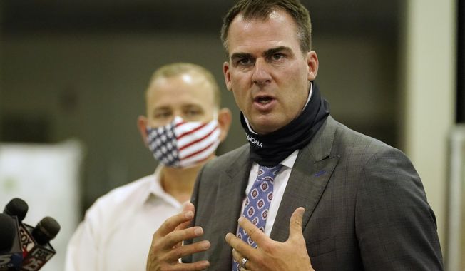 FILE - In this Aug. 18, 2020 file photo, Oklahoma Gov. Kevin Stitt speaks during a news conference in Oklahoma City. Several Oklahoma House Democrats requested a legal opinion Monday, Sept. 14, 2020 on Republican Gov. Stitt's decision to spend federal coronavirus relief funds to send students to private schools. (AP Photo/Sue Ogrocki File)
