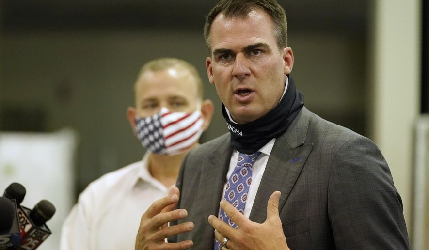 FILE - In this Aug. 18, 2020 file photo, Oklahoma Gov. Kevin Stitt speaks during a news conference in Oklahoma City. Several Oklahoma House Democrats requested a legal opinion Monday, Sept. 14, 2020 on Republican Gov. Stitt's decision to spend federal coronavirus relief funds to send students to private schools. (AP Photo/Sue Ogrocki File)