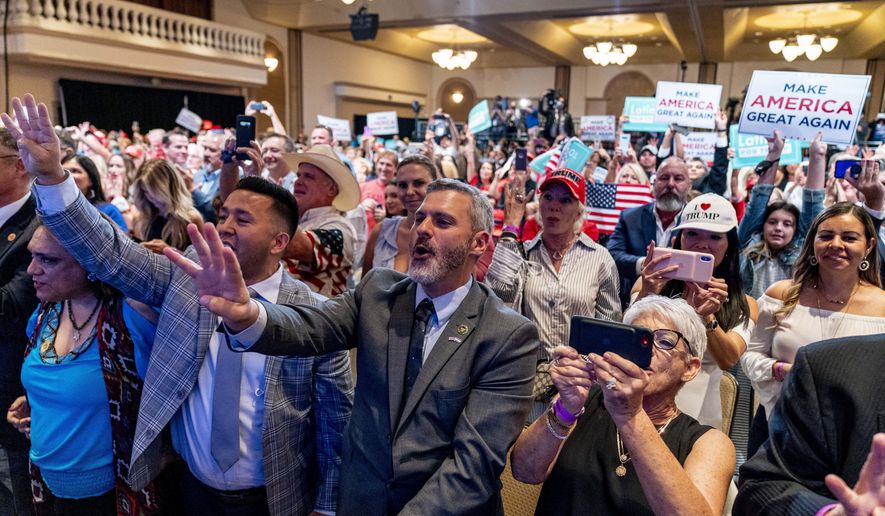 Supporters react as President Donald Trump speaks at a Latinos for Trump Coalition roundtable at Arizona Grand Resort & Spa, Monday, Sept. 14, 2020, in Phoenix. (AP Photo/Andrew Harnik)