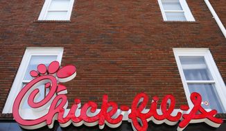 In this Oct. 30, 2018, photo, Chick-fil-A signage is displayed in downtown, Athens, Ga. Chick-fil-A said Monday, Sept. 14, 2020, that it no longer plans to open a restaurant in the San Antonio airport, even though the Texas city relented and agreed to let it do so after more than a year of legal wrangling. (Joshua L. Jones/Athens Banner-Herald via AP) **FILE**