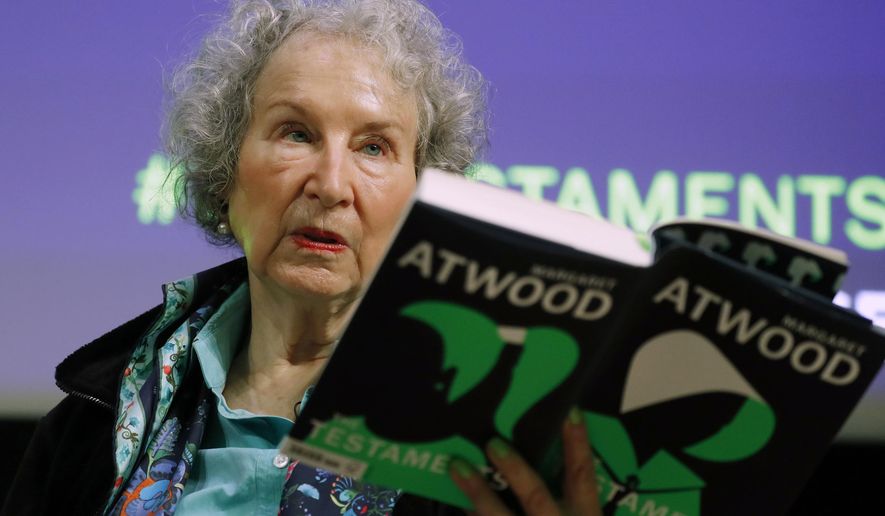 FILE - In this Sept. 10, 2019, file photo, Canadian author Margaret Atwood holds a copy of her book &amp;quot;The Testaments,&amp;quot; during a news conference in London. Atwood, whose sweeping body of work includes &amp;quot;The Handmaid&#39;s Tale,&amp;quot; depicting a nightmarish future for the United States, is this year&#39;s winner of a lifetime achievement award celebrating literature&#39;s power to foster peace, social justice and global understanding, officials of the Dayton Literary Peace Prize officials announced Monday, Sept. 14, 2020. (AP Photo/Alastair Grant, File)