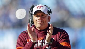 In this Dec. 31, 2019, file photo, Virginia Tech head coach Justin Fuente reacts after his team scored against Kentucky in the first half of the Belk Bowl NCAA college football game in Charlotte, N.C. Fuente said he takes the impact of the coronavirus pandemic personally and that he supports team medical experts who say it was the “exact right call” to postpone the Hokies&#39; scheduled upcoming game against Virginia. (AP Photo/Nell Redmond, File)  **FILE**