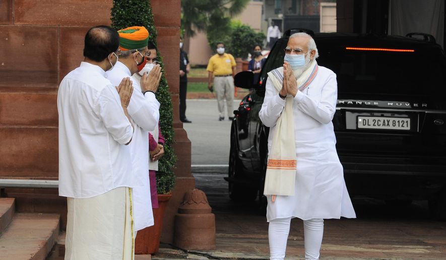 Indian Prime Minister Narendra Modi, right is received by his ministerial colleagues as he arrives at the Parliament in New Delhi, India, Monday, Sept.14, 2020. Indian lawmakers have returned to Parliament after more than five months even as coronavirus cases continue to surge at the fastest pace than anywhere else in the world. (AP Photo)