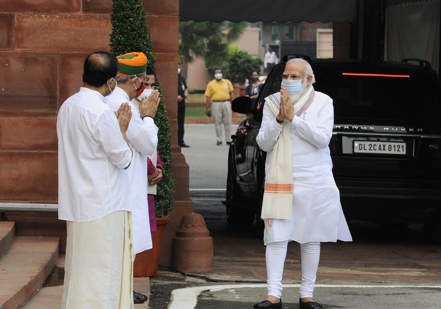 Indian Prime Minister Narendra Modi, right is received by his ministerial colleagues as he arrives at the Parliament in New Delhi, India, Monday, Sept.14, 2020. Indian lawmakers have returned to Parliament after more than five months even as coronavirus cases continue to surge at the fastest pace than anywhere else in the world. (AP Photo)
