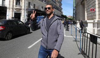 FILE - In this March 10, 2020 file photo, Algerian journalist Khaled Drareni flashes the V sign as he leaves the courthouse in Algiers. An Algerian court sentenced on Tuesday journalist Khaled Drareni to two years in prison on appeal, in a trial that rights group have denounced as violating press freedom. Drareni, editor of the Casbah Tribune news site and Algeria correspondent of RSF and the French TV channel TV5 Monde, played a prominent role in covering the country&#39;s pro-democracy movement last year.(AP Photo/Str, File)