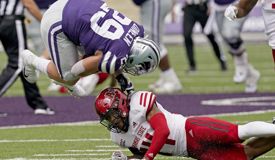Kansas State fullback Jax Dineen (29) is upended by Arkansas State defensive back Antonio Fletcher (14) after catching a pass during the second half of an NCAA college football game Saturday, Sept. 12, 2020, in Manhattan, Kan. (AP Photo/Charlie Riedel)