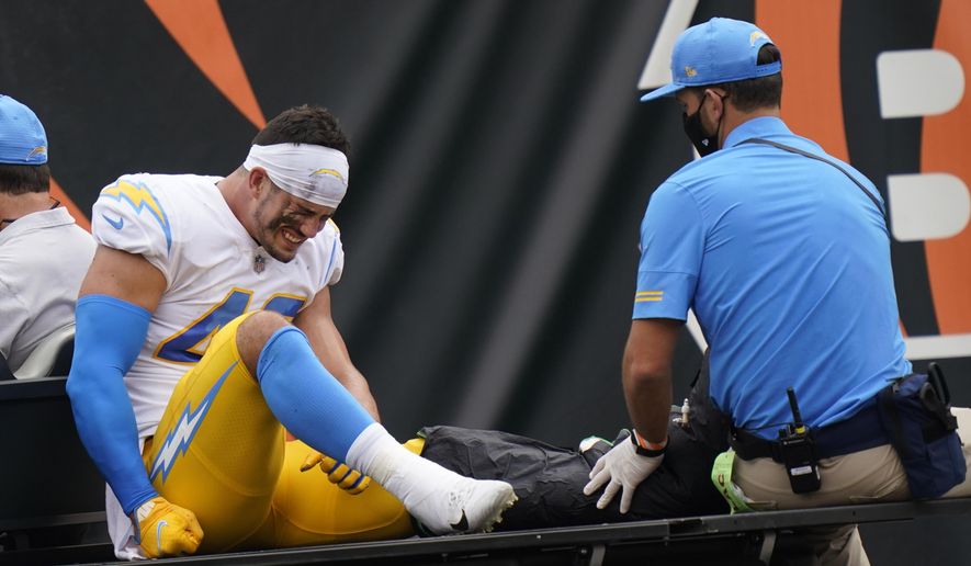 Los Angeles Chargers linebacker Drue Tranquill (49) is carted off the field during the first half of an NFL football game against the Cincinnati Bengals, Sunday, Sept. 13, 2020, in Cincinnati. (AP Photo/Bryan Woolston)