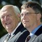 In this Sept. 12, 2003, file photo, William H. Gates Sr., left, smiles while sitting next to his son, Bill Gates Jr., during the dedication and grand opening of the William H. Gates Hall, the new home of the University of Washington School of Law in Seattle. Bill Gates Sr., a lawyer and philanthropist and father of Microsoft co-founder Bill Gates, died Monday, Sept. 14, 2020, at age 94. (AP Photo/John Froschauer, File)