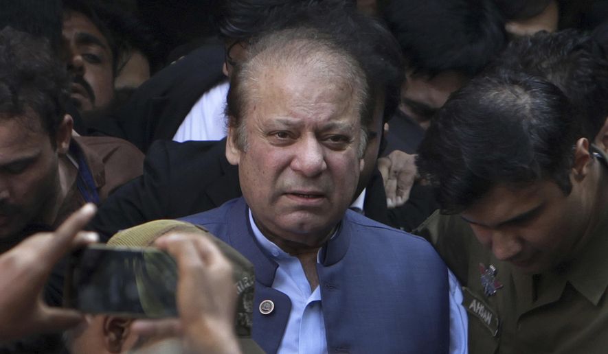 FILE - In this Oct. 8, 2018, file photo, former Pakistani Prime Minister Nawaz Sharif leaves after appearing in a court in Lahore, Pakistan. A Pakistani court on Tuesday Sept. 1, 2020 warned the country&#39;s ailing former Prime Minister Nawaz Sharif to return home by Sept. 10 to face a corruption hearing or risk being declared a fugitive from justice. Sharif has been in London since authorities last November released him so he could travel and seek medical treatment abroad. (AP Photo/K.M. Chaudary, File)