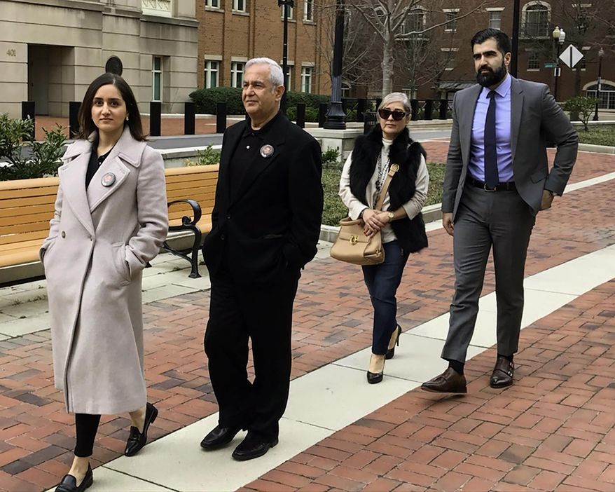 FILE - From left, Negeen Ghaisar, James Ghaisar, Kelly Ghaisar and Kouros Emami, family of Bijan Ghaisar walk outside federal court in Alexandria, Va., on Friday, March 6, 2020. Two U.S. Park Police officers say they gave “chance after chance” to a northern Virginia man in a stop-and-go police chase before firing 10 shots that killed him in 2017. Documents made public Tuesday, Sept. 15, 2020 in a civil suit filed by the parents of 25-year-old Bijan Ghaisar provide the first real insight into the thought process of the two officers who shot and killed Ghaisar after a chase on the George Washington Parkway. (AP Photo/Matthew Barakat)
