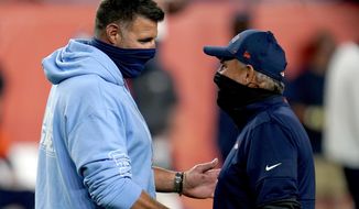 Tennessee Titans head coach Mike Vrabel, left, greets Denver Broncos head coach Vic Fangio prior to an NFL football game, Monday, Sept. 14, 2020, in Denver. (AP Photo/David Zalubowski)