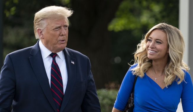 President Donald Trump, accompanied by White House press secretary Kayleigh McEnany, walks to speak with reporters before boarding Marine One on the South Lawn of the White House, Tuesday, Sept. 15, 2020, in Washington. Trump is en route to Philadelphia. (AP Photo/Alex Brandon) ** FILE **